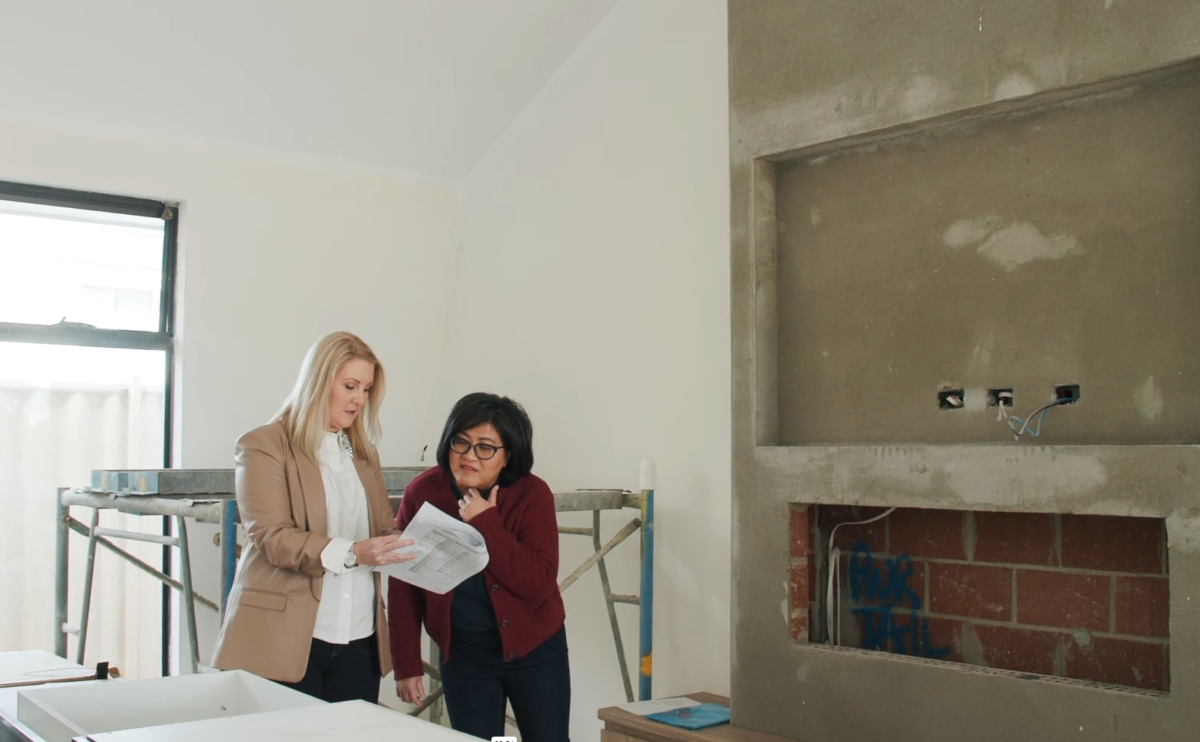 Luxury home in progress as Project Manager Allie and client Rosa lookover bespoke plans at custom-built home, the Villa Rosa by Oswald Homes