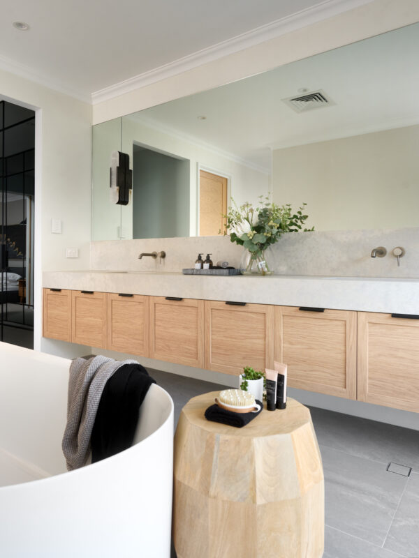 long wooden vanity with freestanding bathtub