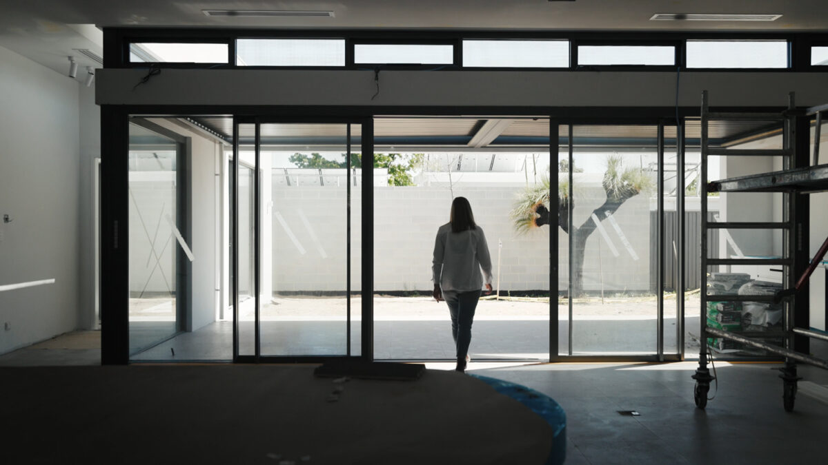 Open sliding glass doors leading to bright undercover alfresco area