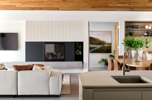 open plan Kitchen, living and dining area with statement fireplace and wooden ceiling