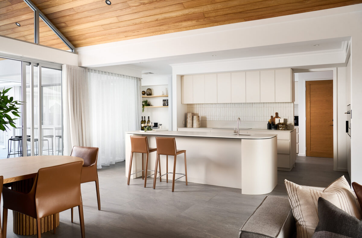 curvey, neutral kitchen with brown leather chairs