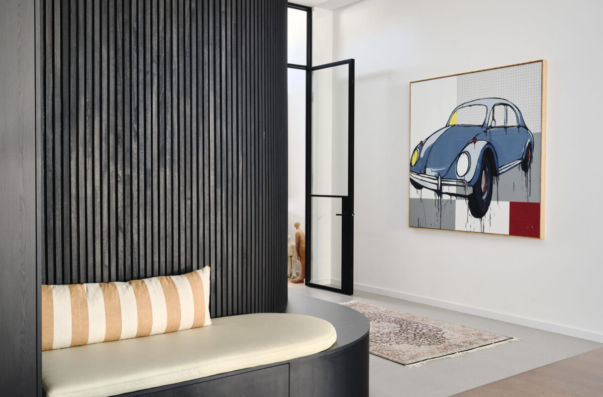Curved black batten feature wall with built in bench seat