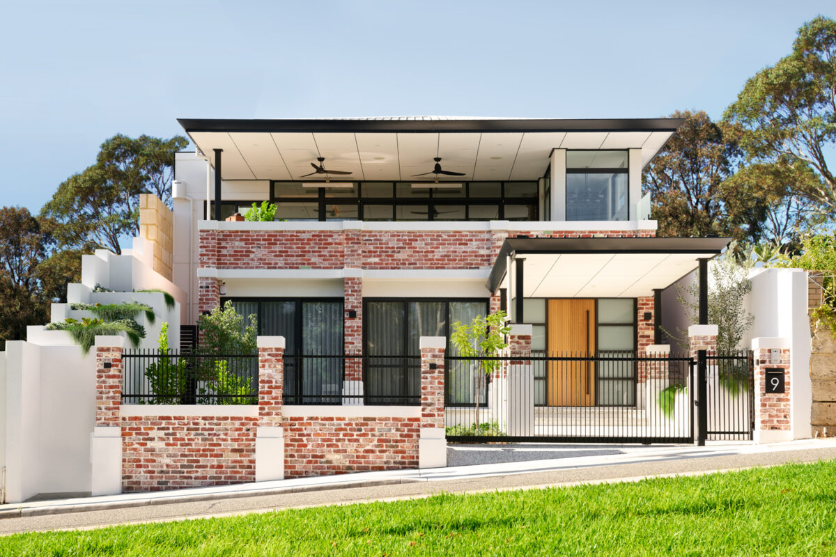 The Artisan is a modern, industrial luxury custom home, featuring red exposed recycled brickwork, and clever use of black exterior, and wood elements to tie in the finer details of this bespoke custom home. Built by luxury home builders, Oswald Homes.