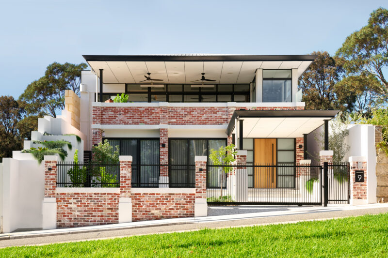 The Artisan is a modern, industrial luxury custom home, featuring red exposed recycled brickwork, and clever use of black exterior, and wood elements to tie in the finer details of this bespoke custom home. Built by luxury home builders, Oswald Homes.
